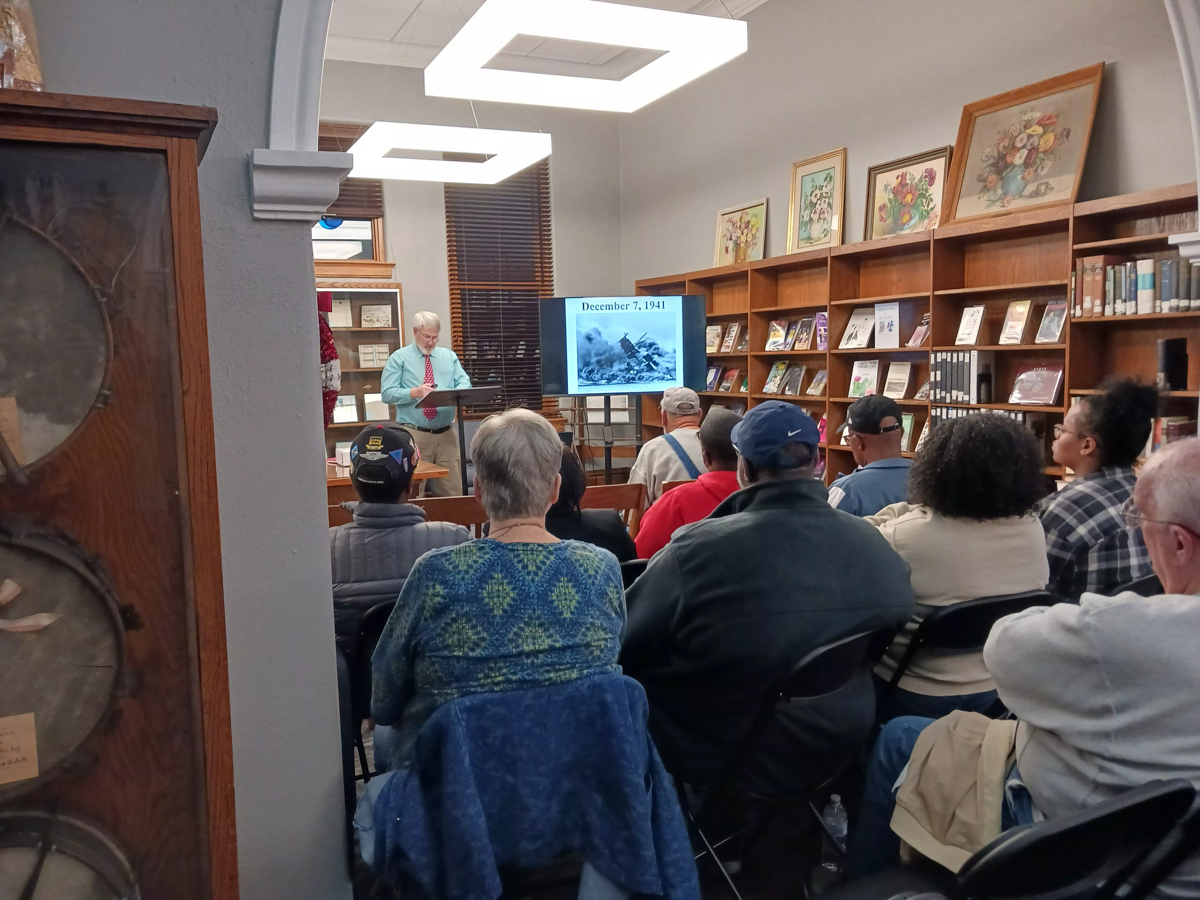 local man presenting history program to seated crowd