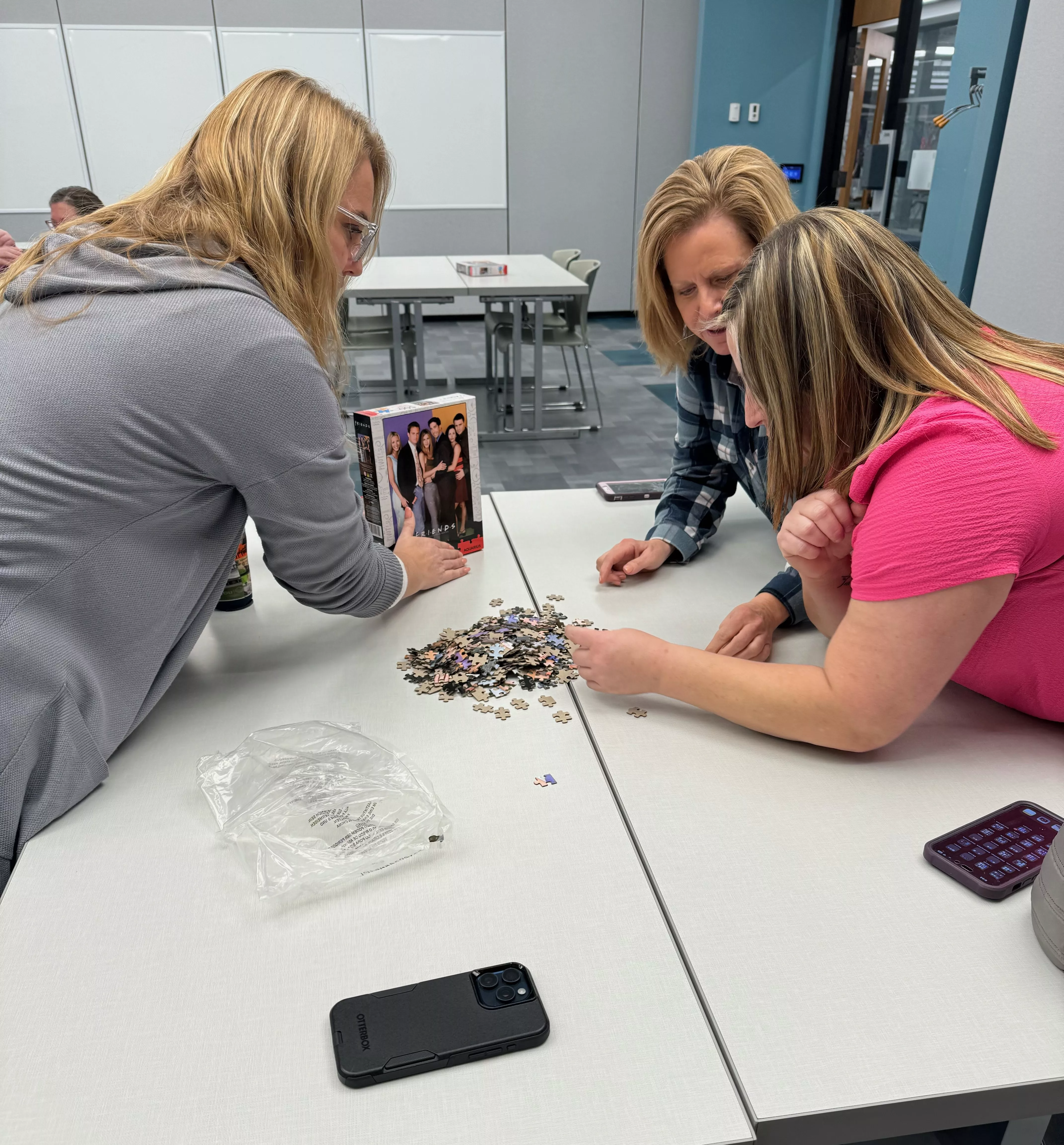 3 ladies solving a jigsaw puzzle